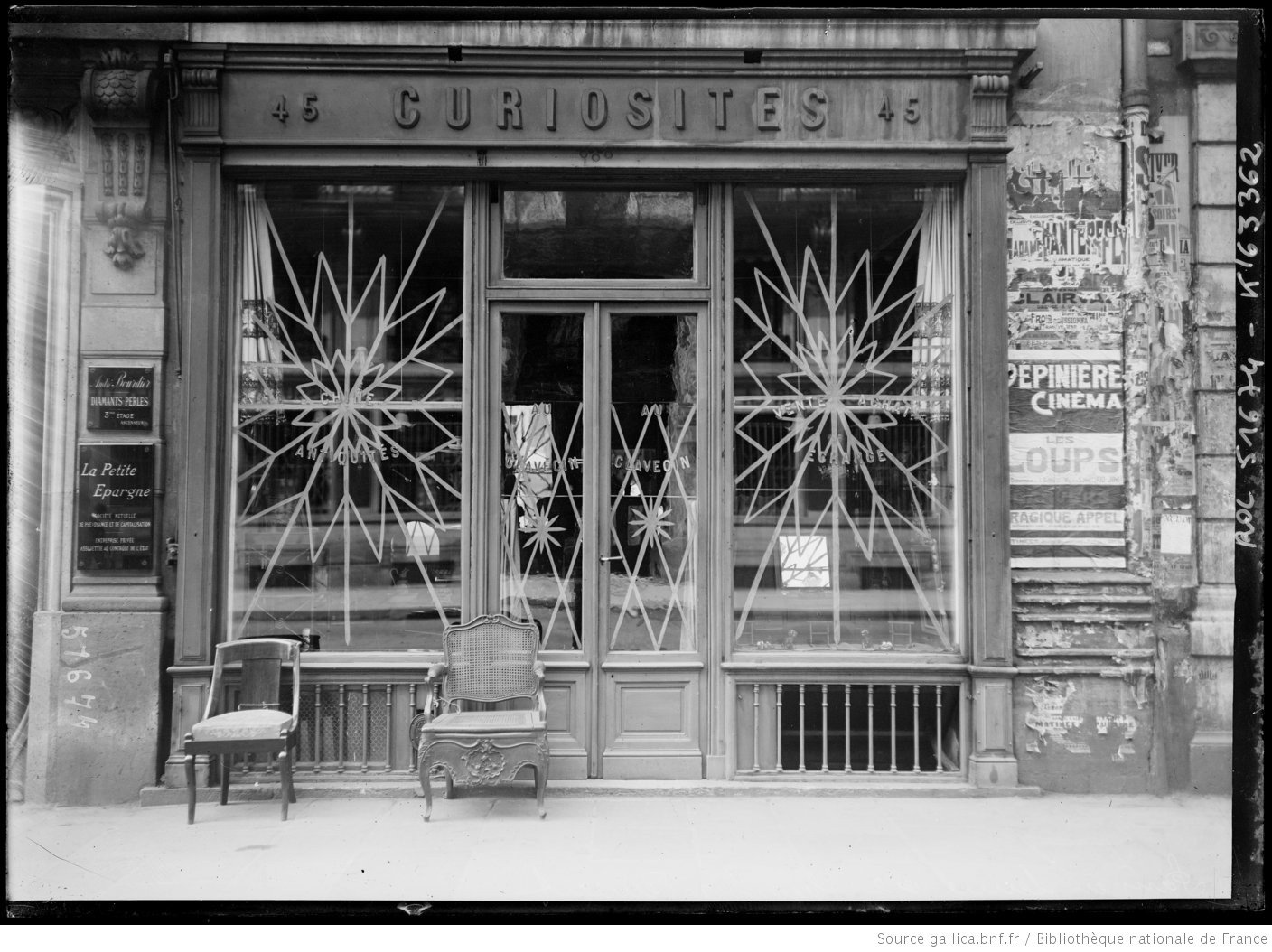 Photo of paris shop window with tape art on it.