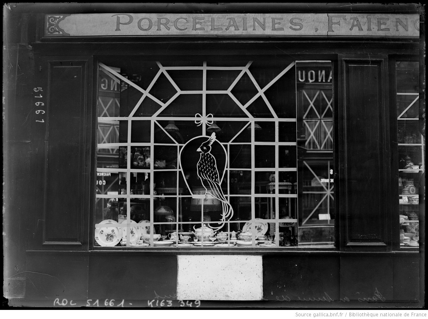 Photo of paris shop window with tape art on it.